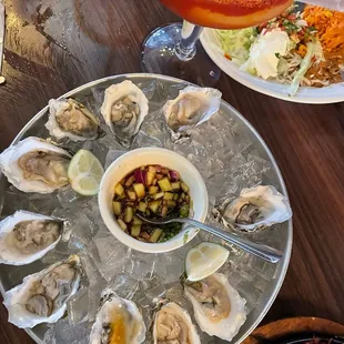 a platter of oysters and a cocktail