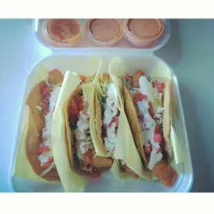 three tacos in a styrofoam container