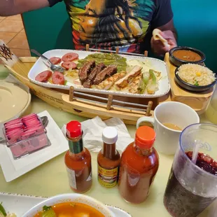a man sitting at a table full of food