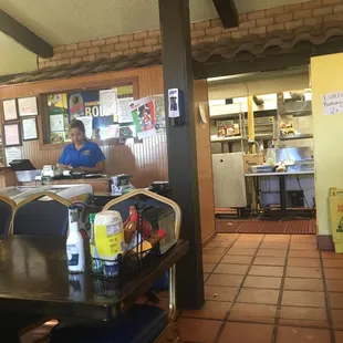 Totally dysfunctional counter for ordering menus are on the way ice cream cooler in the way with condiment spread across the counters