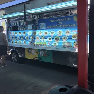 a man standing in front of a food truck