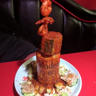 Sea food plate with a can of modelo beer. Wish the beer would have been open and had a little michelada mix and hot sauce in it.