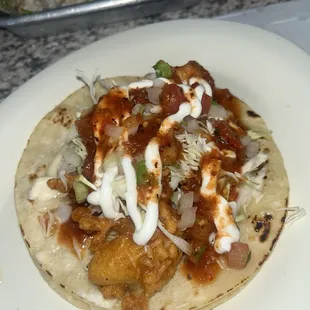 Fish taco with hot sauce