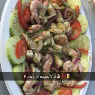 a plate of shrimp and cucumber salad