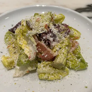 a white plate with a salad on it