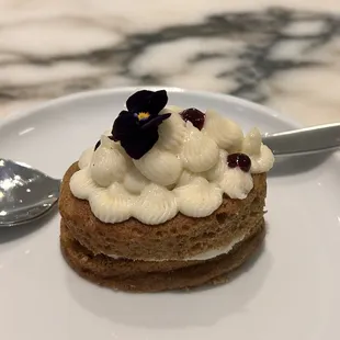 a plate with a pastry and a spoon