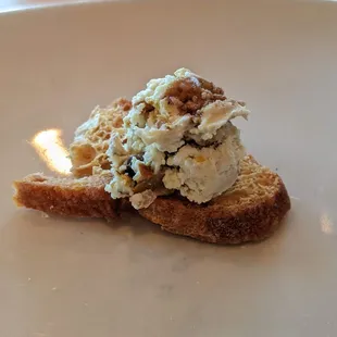 Starter course on the house. goat cheeese and bruschetta topped crostini.