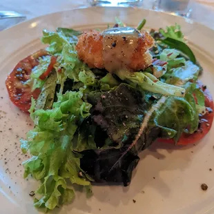 a light salad with a fried oyster on top. yummy.