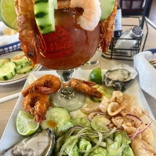 a plate of seafood and a cocktail