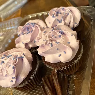 three cupcakes with frosting and sprinkles