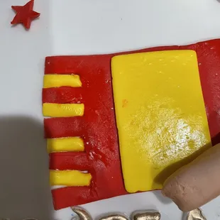 Look at the lettering the paint doesn't look even. The scarf is crooked everywhere as you can see. The stars aren't straight either.