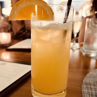 a glass of orange juice on a table