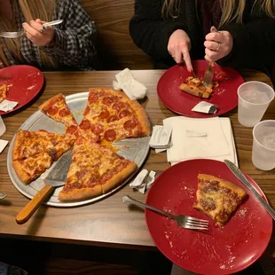 people eating pizza at a restaurant