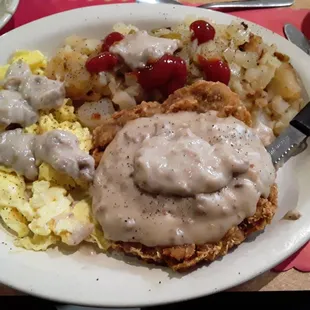 Country Fried Steak with Scrambled Eggs, Home Fries with onions &amp; peppers and Extra Gravy!