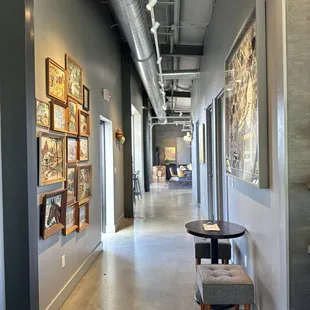 a long hallway with artwork on the walls