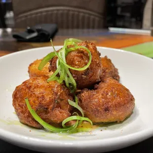 a plate of fried meatballs on a table