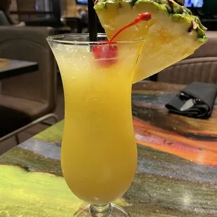 a pineapple drink with a slice of pineapple