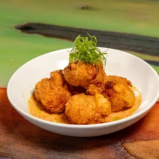 a bowl of fried food on a table