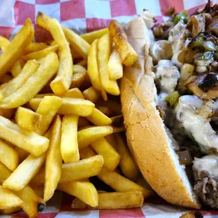 1/2 Cheeseteak with mushrooms and peppers and a mountain of perfect fries for about $14!
