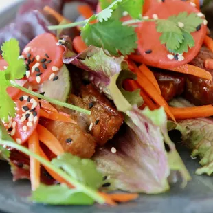 Crispy Pork Belly with &quot;sauce l&apos;orange,&quot; seasonal house pickles, and local lettuce cups.