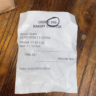 a receipt on a wooden table