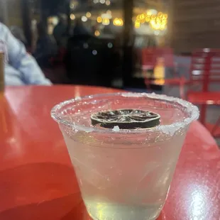 a shot of a drink in a glass on a table