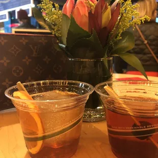two cups of tea and a vase of flowers