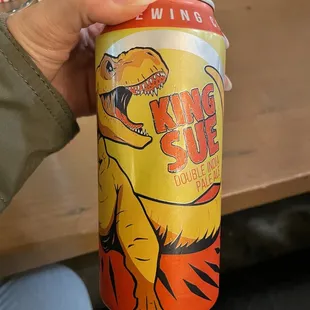a person holding a can of king slug