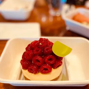a raspberry tart on a white plate