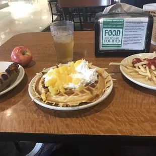 waffles, pizza, and fruit on a table