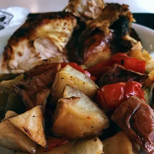 a plate of food with potatoes, peppers, and other vegetables