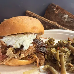 a pulled pork sandwich and green beans