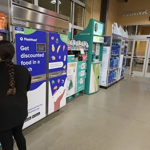 a woman standing in front of a vending machine