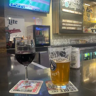 a glass of beer and coasters