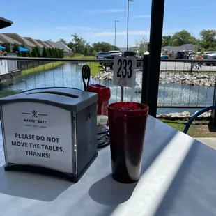 a drink and a sign on a table