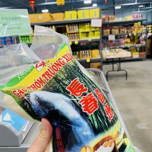 a hand holding a bag of food