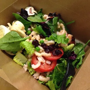 a salad in a box with a fork