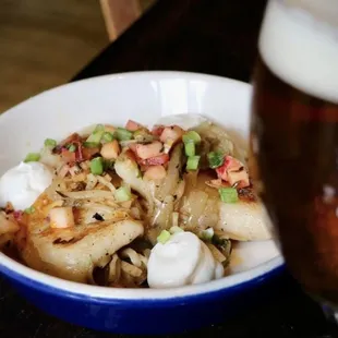 a bowl of food and a glass of beer