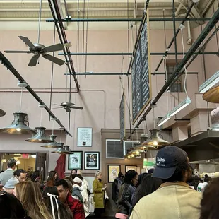 a crowd of people in a food court