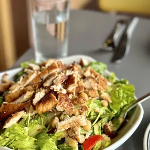 a bowl of salad and a glass of water