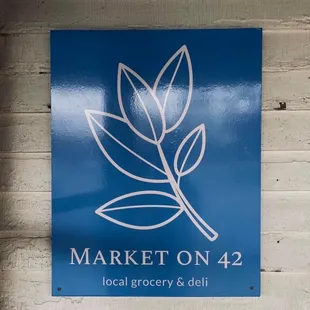 a blue sign on a brick wall