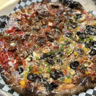 a pizza on a checkered plate