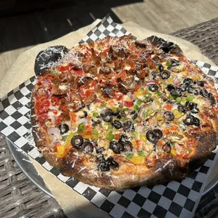 a pizza on a checkered plate