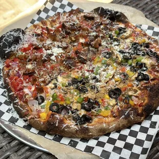 a pizza on a checkered plate