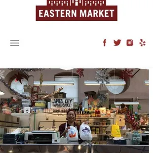 a woman standing behind a counter