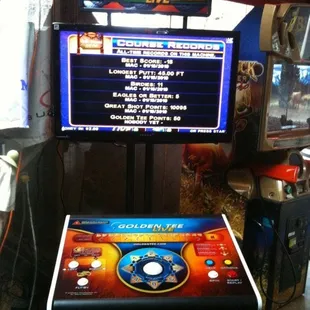 an arcade machine with a golden teef on the screen
