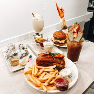 Taylor Shellfish oysters, Connecticut-style lobster roll with fries, cocktail flight, The Bloody Market, Market Burger and fries