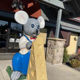 a mouse holding a piece of cheese