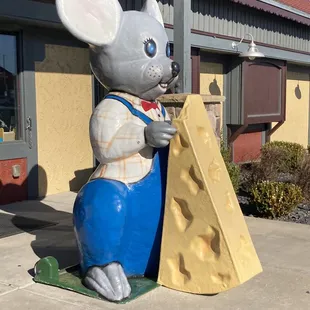 a statue of a mouse holding a piece of cheese