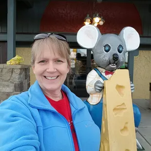 a woman holding a cheese mouse